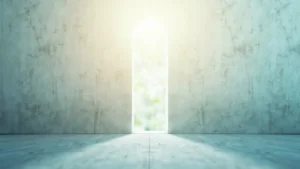 Bright doorway in a textured wall leading to a sunlit outdoor scene